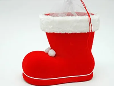A red Santa boot decoration on a white background.