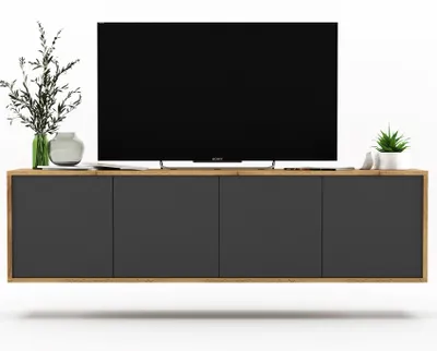 A modern TV stand with a TV on top, and some decorative items.
