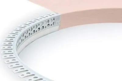 A close-up, curved white plastic trim with perforations is shown along the edge of a beige curved surface.