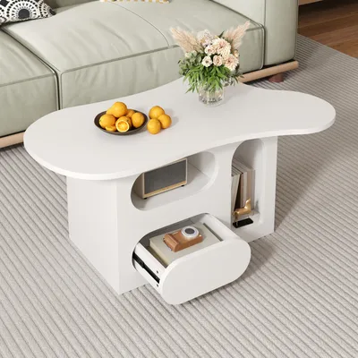 A white, cloud-shaped coffee table with storage compartments, placed on a light gray carpet in a living room setting.