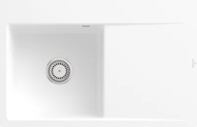 A top-down view of a white kitchen sink with a drain.