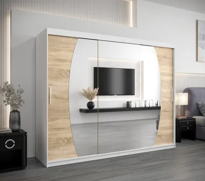 A modern bedroom with a large wardrobe featuring a TV niche.