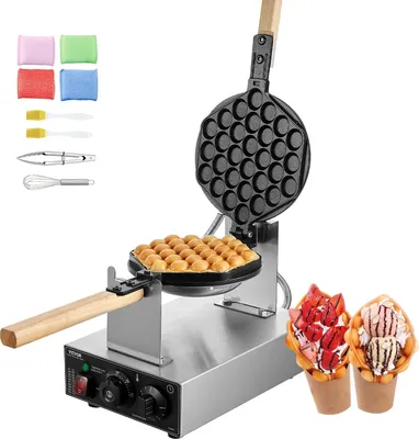 A bubble waffle maker with waffles and finished bubble waffles with toppings.