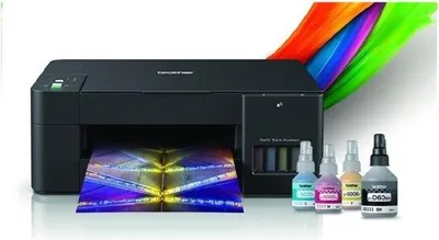 A black Brother printer is shown with a printed colorful image coming out of it, and four bottles of ink next to it.