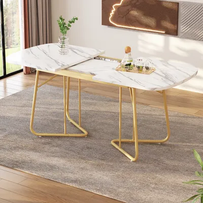 A marble-effect dining table with gold legs is shown in a room setting.