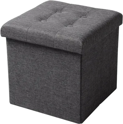 A dark gray fabric storage ottoman with a tufted lid is shown against a white background.