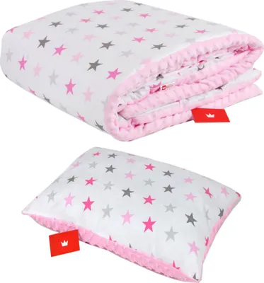 A folded blanket and a pillow, both with a star pattern, are displayed against a white background.