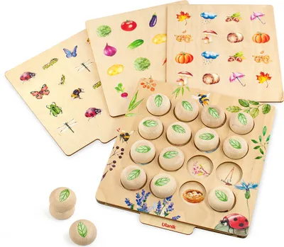 A wooden memory game with various nature-themed cards and game pieces.