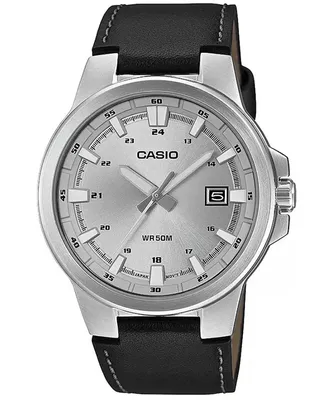 A close-up studio shot of a Casio watch with a silver dial and black leather strap.
