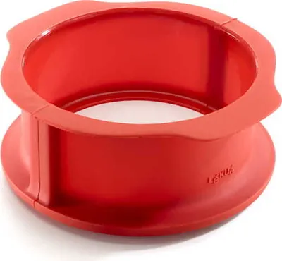 A red silicone springform cake ring is shown against a white background.