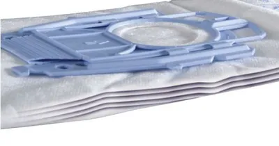 A stack of white vacuum cleaner bags with a blue plastic component on top.