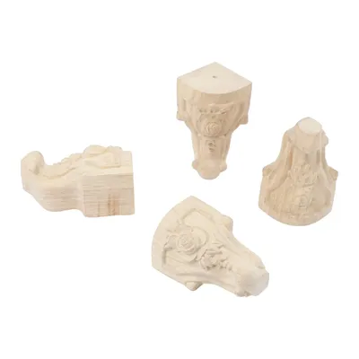 Four carved wooden furniture feet are arranged on a white background.