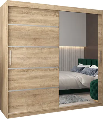 A bedroom scene reflected in the mirrored doors of a wardrobe.