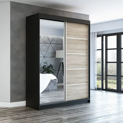 A modern sliding door wardrobe with a mirrored door and wood-effect doors, set in a bedroom.