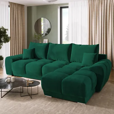 A spacious living room with a large green sectional sofa as the focal point.
