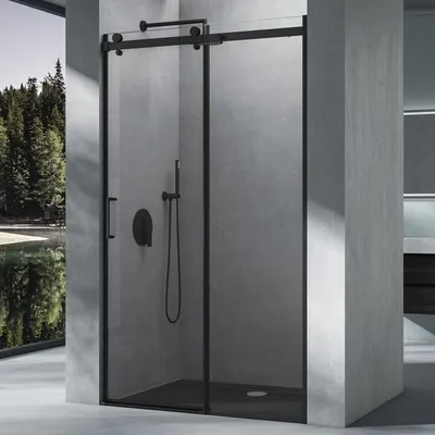 A modern bathroom with a black framed sliding shower door.