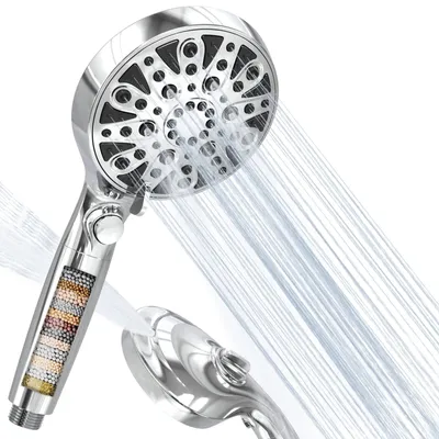 A chrome-finished shower head with multiple spray settings, shown with water spraying from it. Another part of the shower head is visible in the foreground.