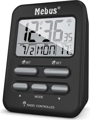 A black digital alarm clock with a display showing the time, date, day, and temperature.