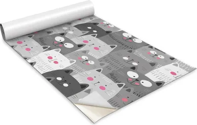 A roll of wallpaper with a pattern of cartoon cats.