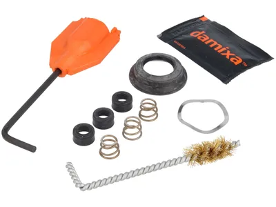A collection of plumbing repair parts and tools, including a wrench, seals, springs, and a brush, laid out on a white background.