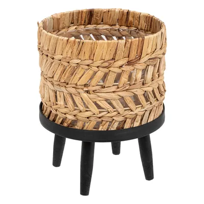A woven planter on a stand.
