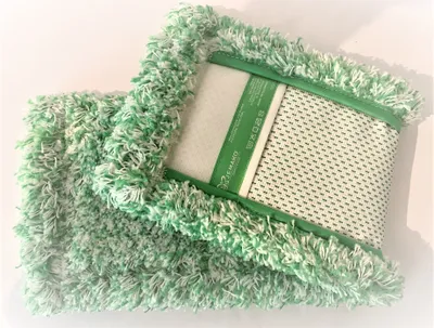 A green and white mop head with a textured backing and a label is shown on a white background.