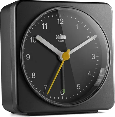 A close-up, angled view of a black Braun alarm clock.