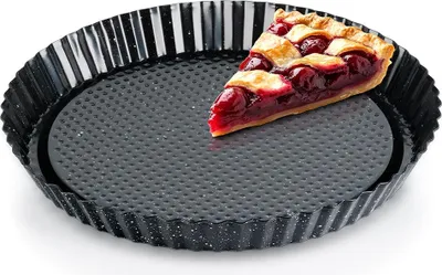 A slice of cherry pie sits in a fluted tart pan.