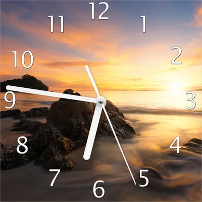Produktbild von Wallario Design Wanduhr Sonne über dem Meer mit Felsenlandschaft aus Echtglas, Größe 20 x 20 cm