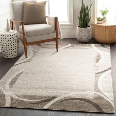 A living room scene with a chair, side table, plants, and a rug.