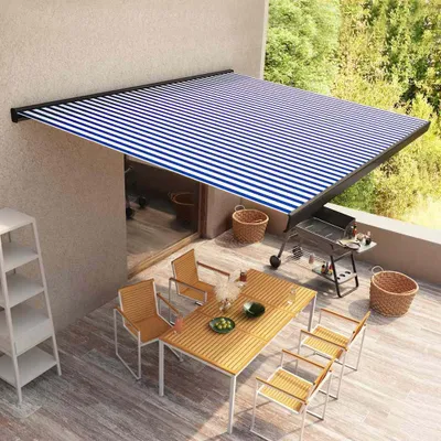 A patio with a dining set and a retractable awning.