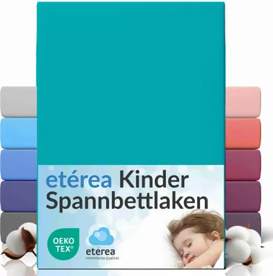 A stack of colorful fitted sheets with a child sleeping on a pillow in the foreground.