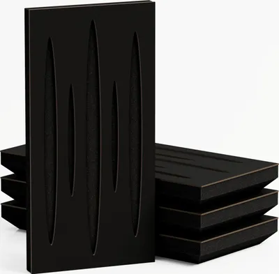 A stack of black acoustic foam panels with cut-out shapes.