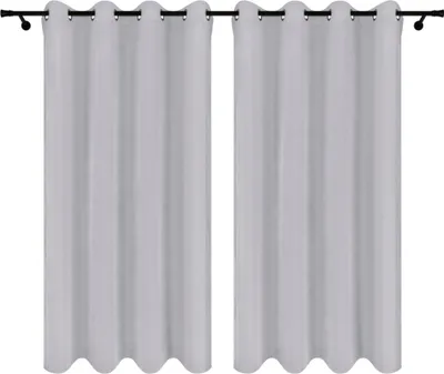 Two gray curtains hanging on a curtain rod against a white background.