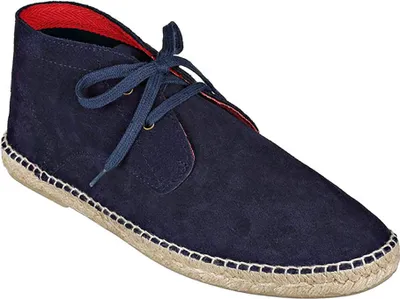 A single blue suede chukka boot with a red lining and a jute sole.