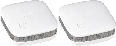 Two white smoke detectors are shown against a white background.