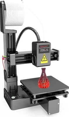 A 3D printer with a printed vase on its platform.