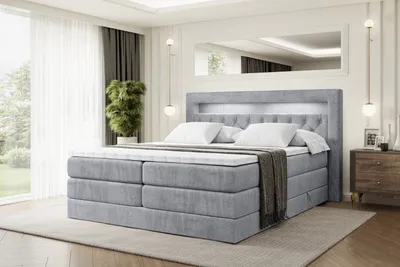 A bedroom scene with a bed, nightstand, and window.