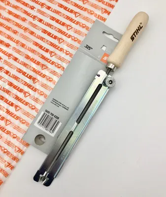 A STIHL file holder with a round file for chainsaw chains, presented on a white background with some packaging.