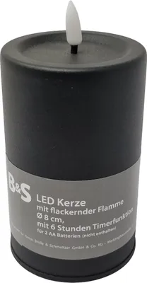 A black LED candle with a flickering flame and product information on a label.
