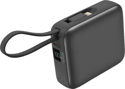 A dark gray power bank with a digital display showing 100% charge, a built-in Lightning cable, and a fabric loop attached.