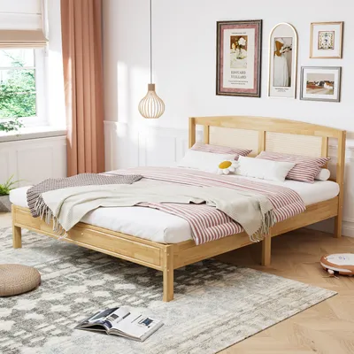 A bedroom scene with a wooden bed and bedding.