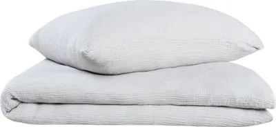 A folded duvet and a pillow, both in light gray, are stacked on top of each other against a white background.