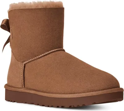 A single brown Ugg boot with a bow on the back, shown from the side against a white background.