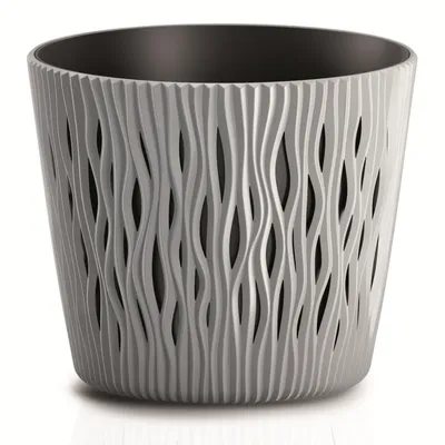 A gray plastic planter with a wavy, cut-out design and a black interior.