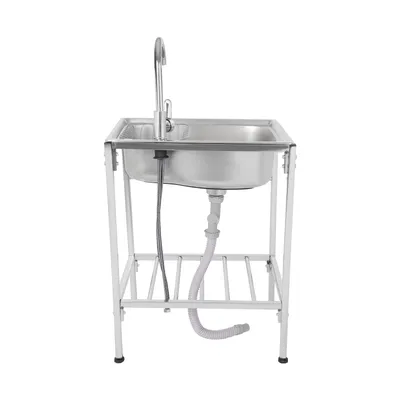 A stainless steel sink with a faucet and drainpipe, mounted on a white metal stand.
