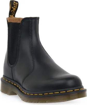 A black Dr. Martens boot on a white background.