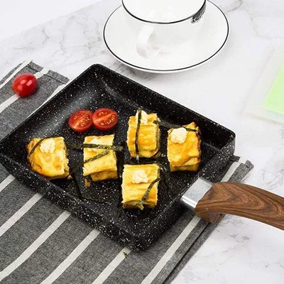 Obrázek produktu pro Japonská pánev na tamagoyaki pro plynové a indukční sporáky, s tepelně izolovanou rukojetí pro dokonalou přípravu vajec a steaků.