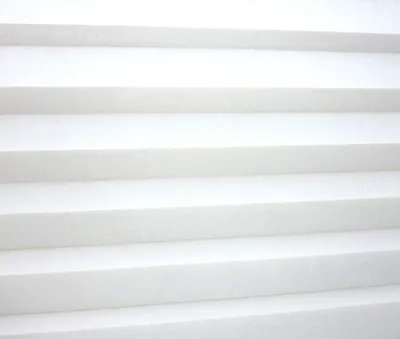 A close-up, abstract view of white pleated blinds.