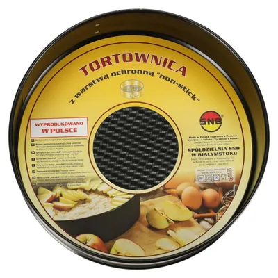 A round cake pan with a non-stick coating, shown with ingredients like apples and eggs.